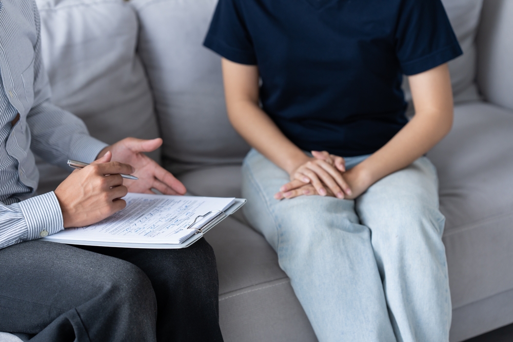 sad female sitting on sofa Patient discussing mental health issues